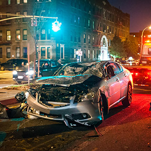   Car wreck at night on a poorly lit street. Title: Slip and Fall – Poor Lighting.  